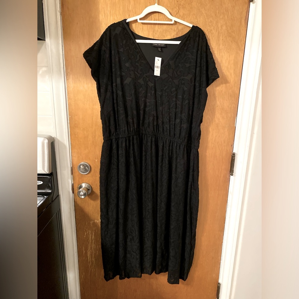 Black sheer floral dress with lining, pockets and elastic waist. Below knee